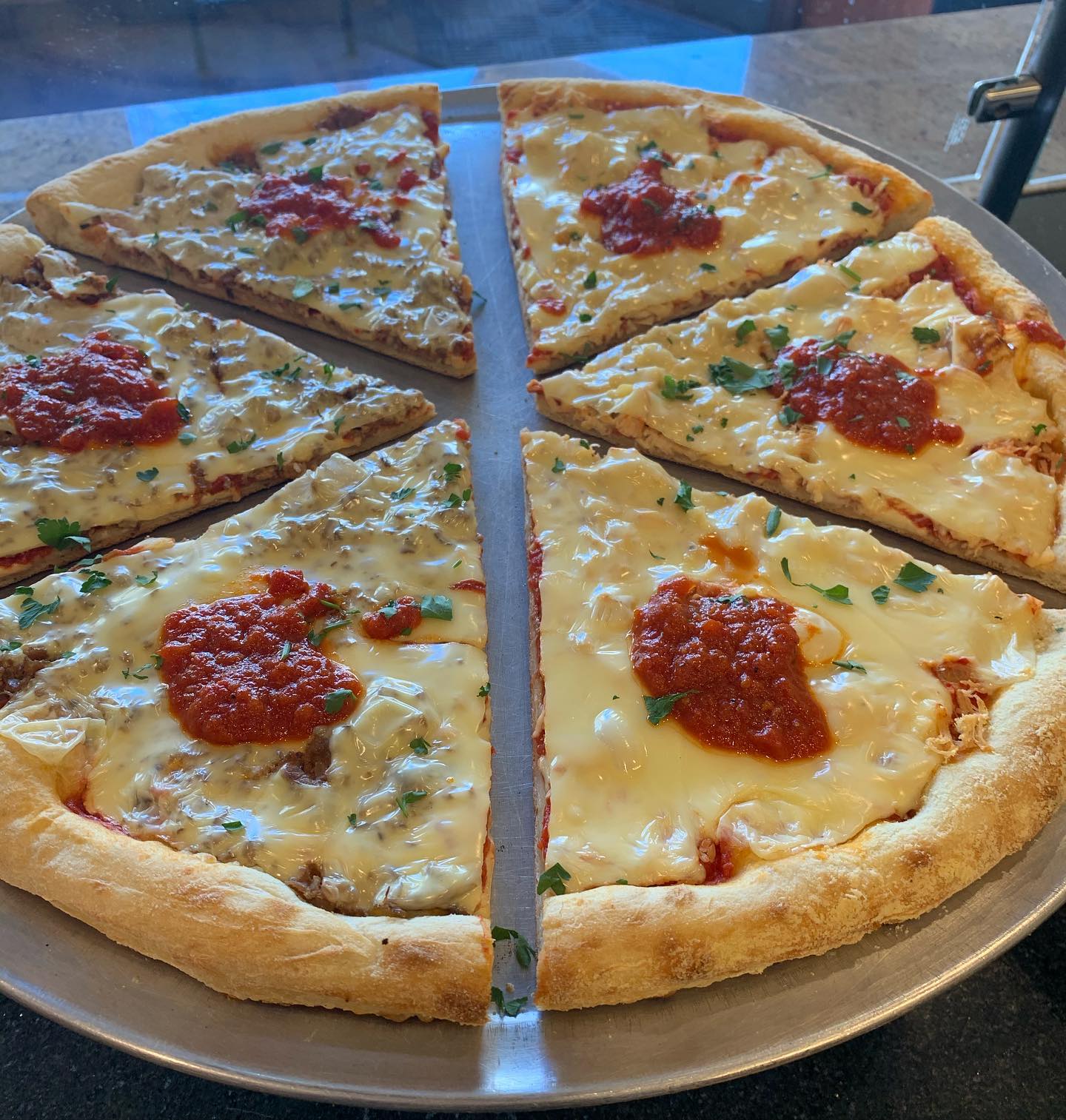 A slice of pizza on a metal pan.