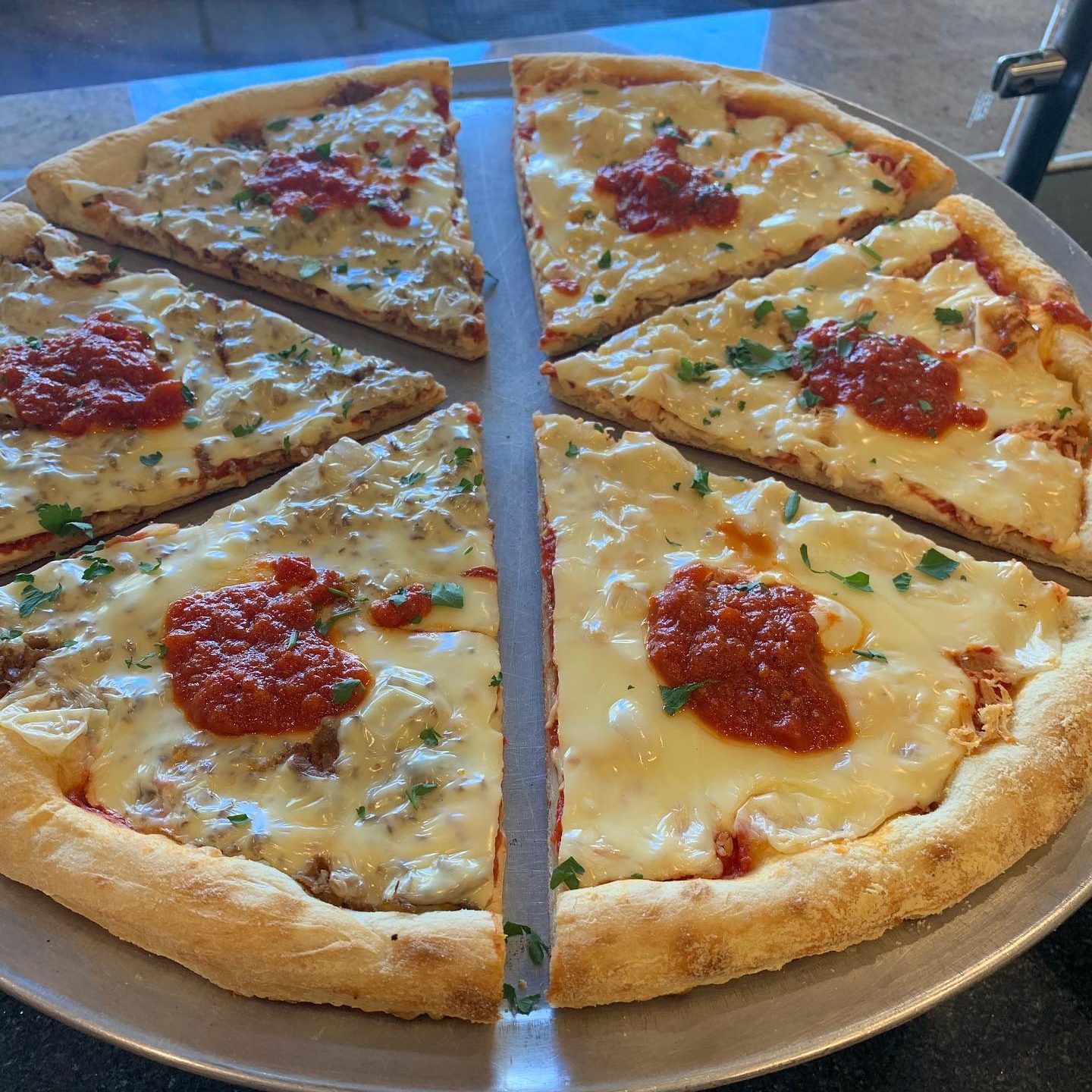 A slice of pizza on a metal pan.